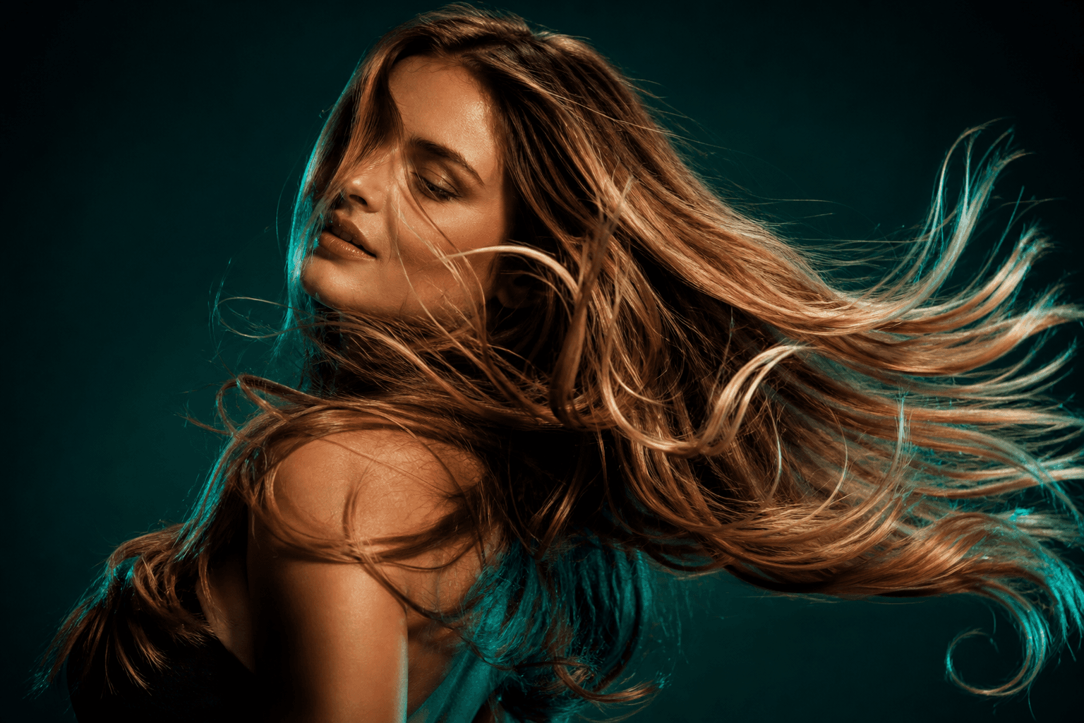 Hair in motion against deep teal light